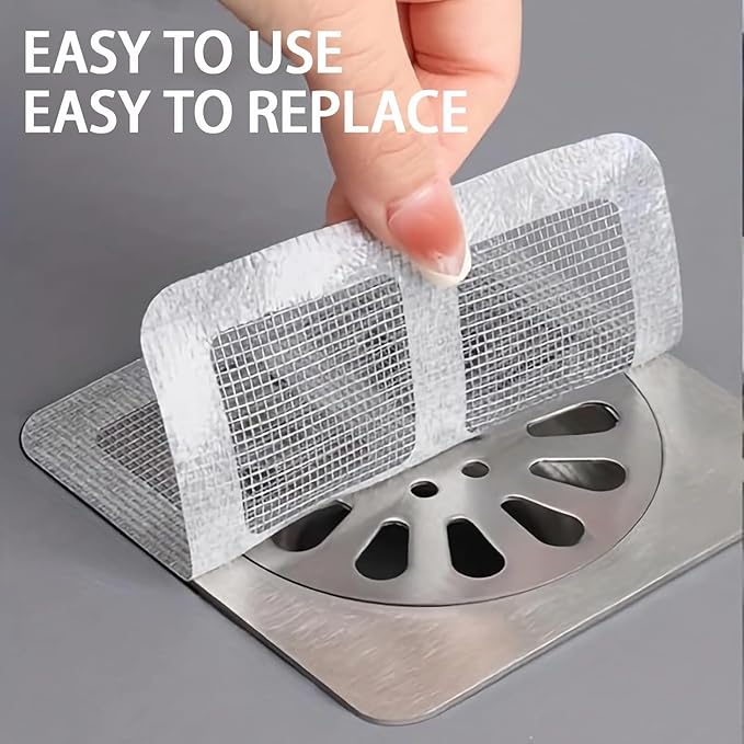 Hand applying shower mesh drain catcher stickers over stainless steel shower drain showing easy peel and replace