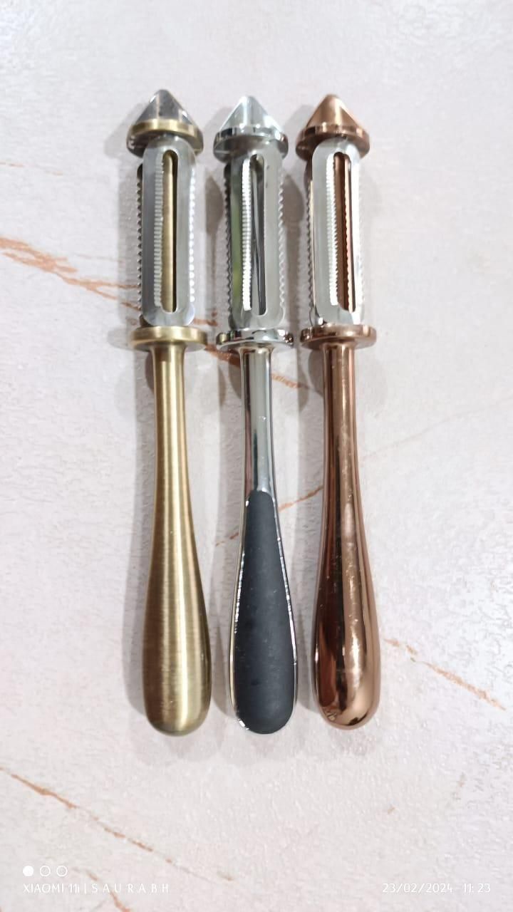 Set of three multifunctional fruit and vegetable peelers in gold, silver, and bronze finishes