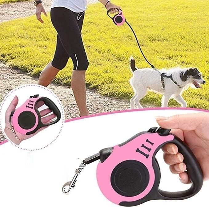 Person walking small white dog on grass with pink retractable 500 cm pet leash multicolor ergonomic handle