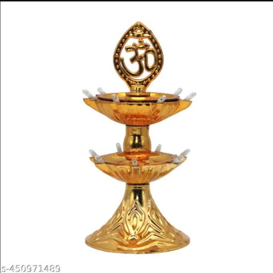 Gold two tier metal oil lamp with Om symbol topper and ornate base decorative diya for Diwali pooja