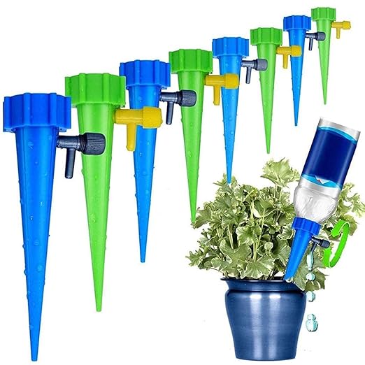 Blue and green adjustable spike drippers with bottle adapter watering a potted plant self-watering system for indoor plants