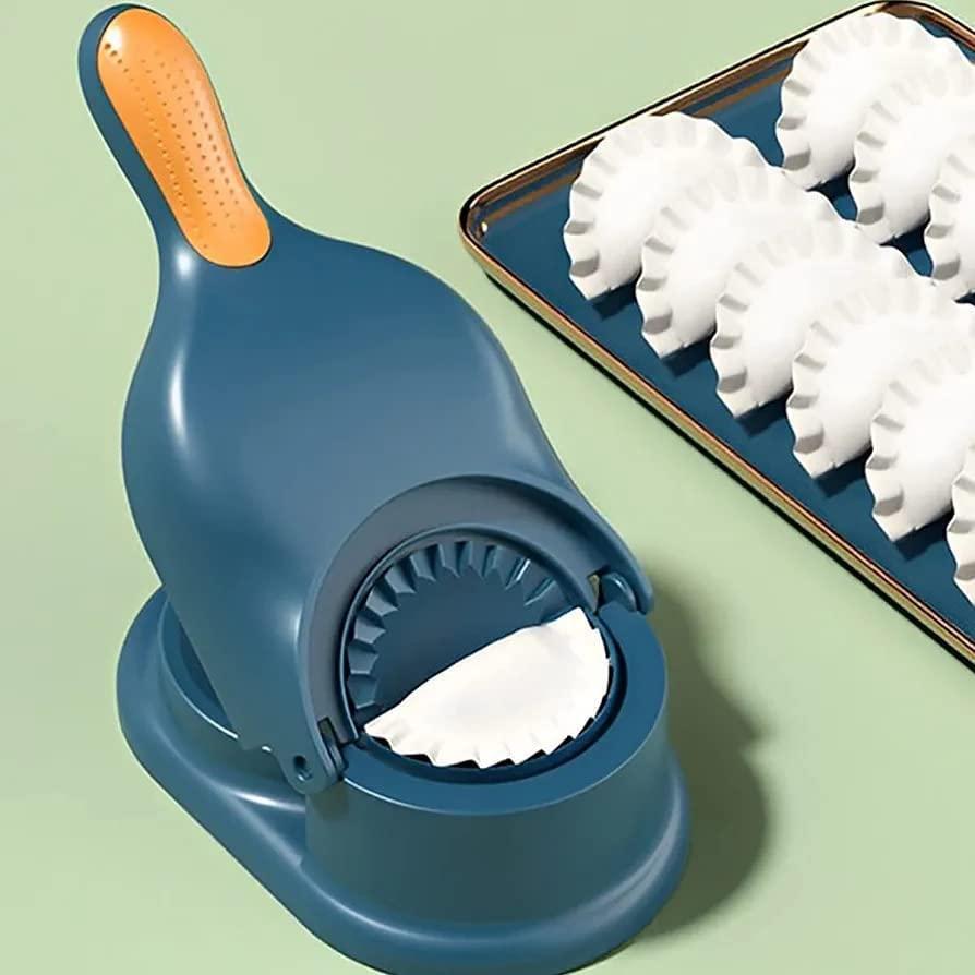 Ghujiya and momos machine in teal with a tray of freshly made momos beside it