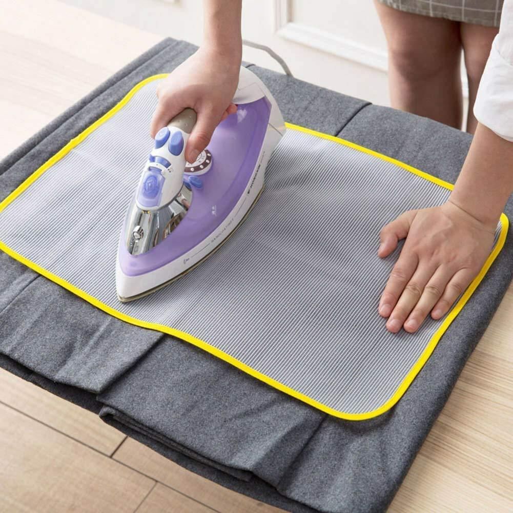 Iron safety mesh pad with yellow trim used under an iron for safe and efficient steaming