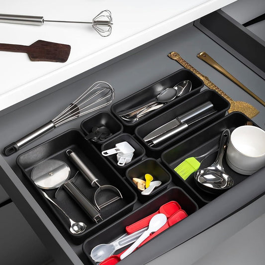 Multi-compartment drawer organizer with various kitchen utensils neatly arranged for easy access